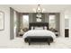 Modern bedroom featuring a black headboard, neutral tones, and plenty of natural light from two windows at 20897 S 231St Pl, Queen Creek, AZ 85142