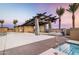 Enjoy outdoor living with a fire pit, palm trees, and poolside lounging at the community amenity center at 20897 S 231St Pl, Queen Creek, AZ 85142