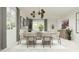Bright dining area with contemporary light fixture, neutral furnishings, and large windows, ideal for entertaining guests at 20897 S 231St Pl, Queen Creek, AZ 85142