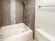 Bathroom featuring decorative tile accent, a shower head, and a new commode at 2121 S Pennington -- # 58, Mesa, AZ 85202
