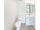 Updated half bathroom featuring a modern vanity, fixtures, and a new commode on wood-look floors at 2121 S Pennington -- # 58, Mesa, AZ 85202
