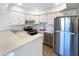 Well-lit kitchen with white cabinets, stainless steel appliances, and white subway tile backsplash at 2121 S Pennington -- # 58, Mesa, AZ 85202