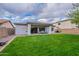 The private backyard offers a covered patio, lush lawn, and ample space for outdoor activities and entertaining at 21289 E Lords Way, Queen Creek, AZ 85142