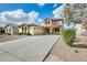 Charming two-story home features desert landscaping and a long, paved driveway at 21366 E Alyssa Rd, Queen Creek, AZ 85142
