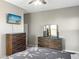 Bedroom features coordinating dresser sets, neutral walls, and ceiling fan at 22635 N Rummler Ln, Maricopa, AZ 85138