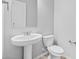 Neat bathroom with a pedestal sink, toilet, and modern hardware fixtures at 23146 E Canary Way, Queen Creek, AZ 85142
