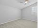 Neutral bedroom featuring a ceiling fan and a window with white shutters at 23146 E Canary Way, Queen Creek, AZ 85142