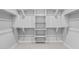 Spacious white walk-in closet with shelving and hanging rods for ample storage at 23146 E Canary Way, Queen Creek, AZ 85142