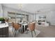 Bright dining area with modern table set and sliding glass doors to the backyard at 23146 E Canary Way, Queen Creek, AZ 85142