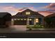Charming single-Gathering home featuring stone accents, a brick driveway, and a perfectly manicured front lawn at 23146 E Canary Way, Queen Creek, AZ 85142