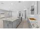Open-concept kitchen featuring a large granite island and stainless steel appliances at 23146 E Canary Way, Queen Creek, AZ 85142