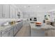 Modern kitchen showcasing gray cabinets, a large granite island, and stainless steel appliances at 23146 E Canary Way, Queen Creek, AZ 85142