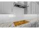 Close up of range vent and granite counters with tile backsplash in kitchen at 23146 E Canary Way, Queen Creek, AZ 85142