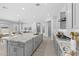 Open-concept kitchen featuring a large granite island and stainless steel appliances opening up to the living area at 23146 E Canary Way, Queen Creek, AZ 85142