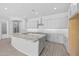 Modern kitchen showcasing gray cabinets, a large granite island, and an open floor plan at 23146 E Canary Way, Queen Creek, AZ 85142