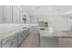 Modern kitchen showcasing gray cabinets and a large granite island at 23146 E Canary Way, Queen Creek, AZ 85142