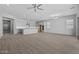 Spacious open-concept living area with wood-look tile floors and stainless steel appliances at 23146 E Canary Way, Queen Creek, AZ 85142