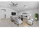 Stylishly staged living room with modern furnishings, a ceiling fan, and neutral decor at 23146 E Canary Way, Queen Creek, AZ 85142