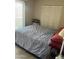 Cozy bedroom with a large window, spacious closet, and a comfortable bed setting at 2605 W Rose Lane -- # B201, Phoenix, AZ 85017