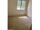 Simple, carpeted bedroom with neutral walls, a bright window, and ample natural light at 2605 W Rose Lane -- # B201, Phoenix, AZ 85017