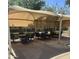 Inviting shaded patio area with tables and chairs, perfect for outdoor gatherings and relaxation at 2605 W Rose Lane -- # B201, Phoenix, AZ 85017