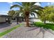 Beautiful backyard with lush green grass, a fire pit, and mature landscaping at 2818 E Malapai Dr, Phoenix, AZ 85028
