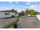 Backyard features lush green grass, a desert landscaped yard, and mature landscaping at 2818 E Malapai Dr, Phoenix, AZ 85028