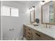 Bright bathroom with a double sink vanity, marble countertops, and modern fixtures and bright lighting at 2818 E Malapai Dr, Phoenix, AZ 85028