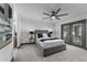 Comfortable bedroom featuring a gray upholstered bed, modern fan, and patio access at 2818 E Malapai Dr, Phoenix, AZ 85028