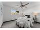 Modern bedroom with bright white walls, ceiling fan, and a large window with plenty of natural light at 2818 E Malapai Dr, Phoenix, AZ 85028