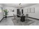 Modern dining area featuring a glass table, gray chairs, contemporary lighting, and artwork at 2818 E Malapai Dr, Phoenix, AZ 85028