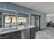 Well-lit kitchen with gray cabinets, stainless steel appliances, and a view of the beautifully landscaped backyard at 2818 E Malapai Dr, Phoenix, AZ 85028