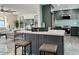 Modern open-concept kitchen features an island with seating and stainless steel appliances at 2818 E Malapai Dr, Phoenix, AZ 85028