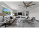 Bright living room with large windows, a modern ceiling fan, and a view to the adjacent room at 2818 E Malapai Dr, Phoenix, AZ 85028
