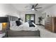 Bright main bedroom with large bed, neutral decor, and a view of the outdoor patio at 2818 E Malapai Dr, Phoenix, AZ 85028