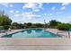 Scenic community pool featuring lounge chairs and well maintained landscaping at 2818 E Malapai Dr, Phoenix, AZ 85028
