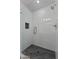 Walk in shower features glass door, rain shower head, and modern fixtures and tile at 2818 E Malapai Dr, Phoenix, AZ 85028