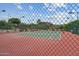 Community tennis court with lighting and mountain views beyond the fence at 2818 E Malapai Dr, Phoenix, AZ 85028