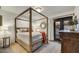 Comfortable bedroom with a wooden canopy bed, natural light, and views of the outdoors at 31 E Bishop Dr, Tempe, AZ 85282