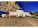 Modern home with desert landscaping, stone accents, and a circular driveway at dusk at 31 E Bishop Dr, Tempe, AZ 85282
