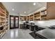 Dedicated home office with built-in shelving and a view to the outdoors at 31 E Bishop Dr, Tempe, AZ 85282