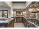 Contemporary kitchen boasts stainless steel appliances, brick backsplash and sleek countertops at 31 E Bishop Dr, Tempe, AZ 85282