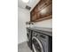 Well-equipped laundry room featuring modern washer/dryer, ample counter space, and stylish wood cabinets at 31 E Bishop Dr, Tempe, AZ 85282