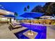 An inviting pool area with tanning ledge, umbrellas, and relaxing lounge chairs at 31 E Bishop Dr, Tempe, AZ 85282