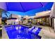 A resort-style pool area with tanning ledge, lounge chairs, and an outdoor kitchen at 31 E Bishop Dr, Tempe, AZ 85282