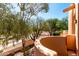 Balcony view with desert landscaping, native tree, and terracotta architecture under a clear sky at 333 N Pennington Dr # 63, Chandler, AZ 85224