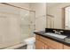 This bathroom has a black sparkle countertop, shower and tub combo, and wood cabinets at 333 N Pennington Dr # 63, Chandler, AZ 85224