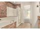 Bathroom featuring a tiled accent wall, bathtub, shower, and glass enclosure at 333 N Pennington Dr # 63, Chandler, AZ 85224