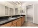 Bathroom featuring dual sinks with granite countertops and wood cabinetry at 333 N Pennington Dr # 63, Chandler, AZ 85224