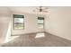 This bedroom has a ceiling fan, neutral carpet, and two windows at 333 N Pennington Dr # 63, Chandler, AZ 85224